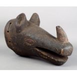 An African rhinoceros mask wood, with painted decoration, 40cm long.