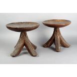 A matched pair of Igbo stools Nigeria with circular tops and carved bases, with quadruple splayed