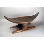 A Surinam Maroons stool South America wood, with metal stud decoration, with a curved eliptical