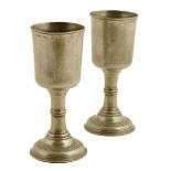 A pair of George II pewter chalices, each with a narrow bowl on a knopped slender stem, the domed