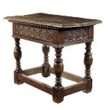 A 17th century oak side table, the boarded top with a moulded edge, above a gadrooned moulding and a