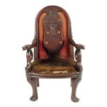 An early 19th century primitive oak open armchair, with an arched back, the splat carved with a lady