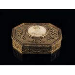 λ A late 19th century French gilt metal jewellery box, the hinged lid inset with a portrait