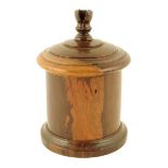 Treen. A 19th century turned lignum vitae string box, the screw-off lid with a cutter finial, 18.4cm