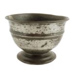 A George I pewter broth bowl, with a lipped rim and a reeded body on a spreading foot, 9.8cm high,