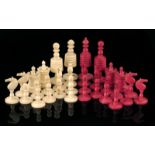 A 19th century turned bone chess set, natural and stained red, the king: 8.5cm high, the pawn: 3.