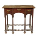 A William and Mary oak writing table, the triple boarded top with a moulded edge above three drawers