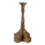 An early 18th century chestnut table candlestand, with a baluster and ring turned stem, on a