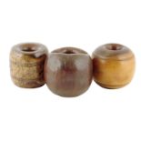 Treen. Three 19th century chogs, hardwood and lignum vitae, 10.5cm diameter (max). (3)