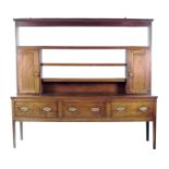 A George III oak dresser, the plate rack with shelves and a pair of panelled cupboards each