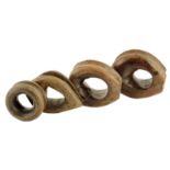 Treen. Four hardwood chogs or ship's pulleys, 14.3cm wide (max). (4)