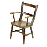 A Victorian beech and elm child's Windor armchair, with traces of original finish.