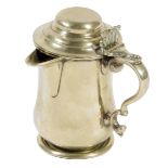 A George II lidded pint tankard, with a spout, the pierced foliate thumbpiece above a scroll handle,