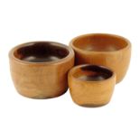 Treen. Three turned lignum vitae wool bowls, 12cm diameter (max). (3)