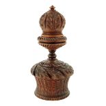 Treen. A carved coquilla nut nutmeg grater, the screw-off acorn finial with a bone and steel
