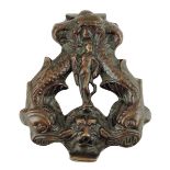 An Italian bronze door knocker, the centre with a hunter with his bow and quiver of arrows flanked