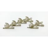 A set of six Edwardian silver menu card holders, by Samuel Jacob, London 1906/8, modelled as a