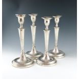 Two similar pairs of George III Old Sheffield plated candlesticks, unmarked, circa 1790, tapering