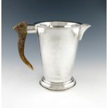 An electroplated water jug, by R.H.V and Co, tapering circular form, stag antler handle, on a