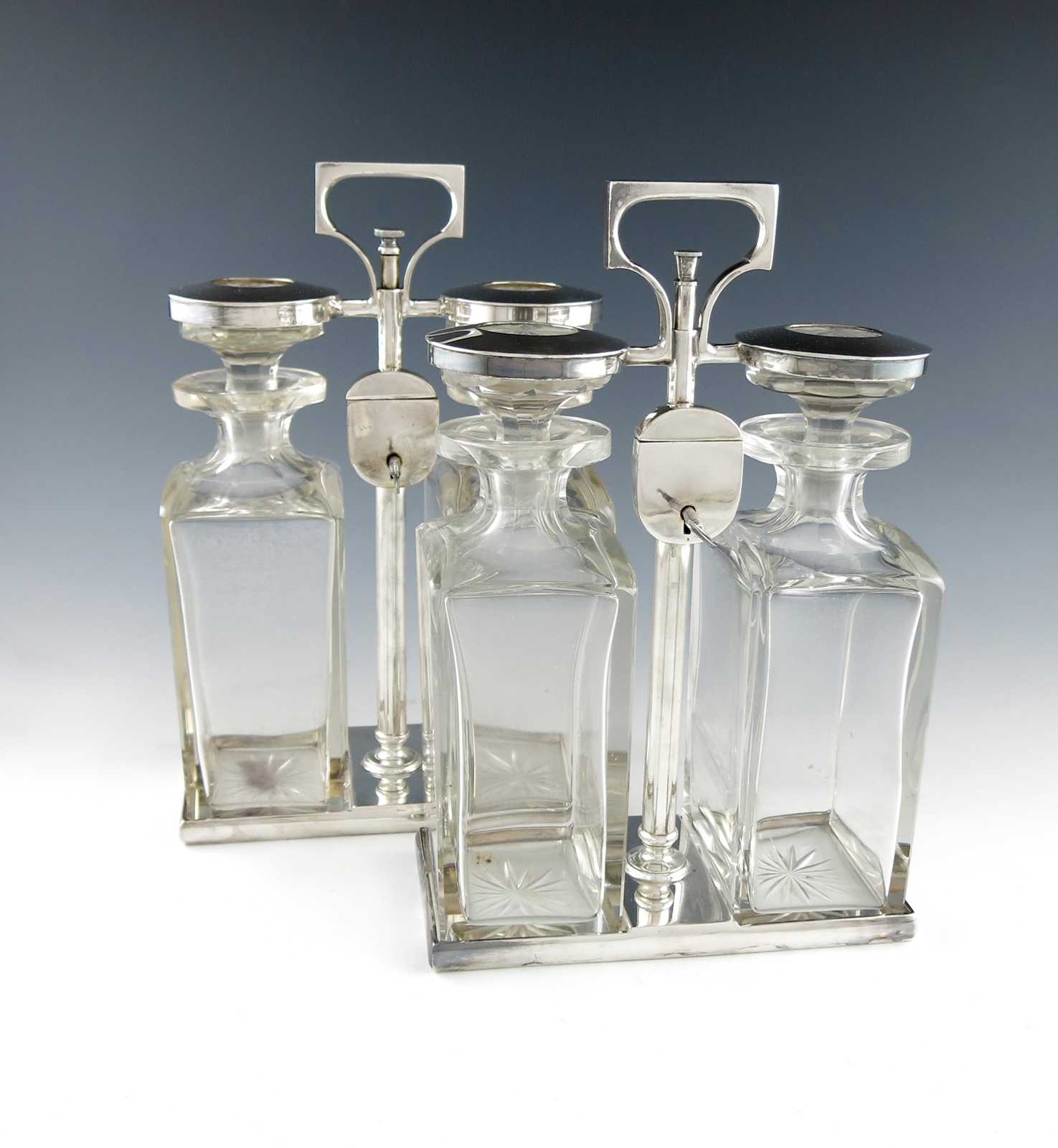 A pair of electroplated two-bottle tantali, by Hukin and Heath, rectangular form, central