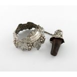 A George IV silver neck ring and bottle stopper, by Samuel Jackson, London 1829, trailing vine and