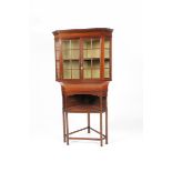 A Liberty & Co mahogany corner display cabinet, triangular section, glazed twin door cabinet over