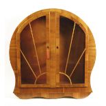 An English Art Deco walnut veneer display cabinet, circular, the glazed doors with sunburst