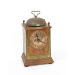 A Continental Secessionist mantel clock, the rectangular oak frame set with brass plates and