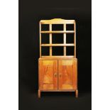 A walnut cupboard with bookshelves by Peter Waals, the twin compartment cupboard with single shelf,