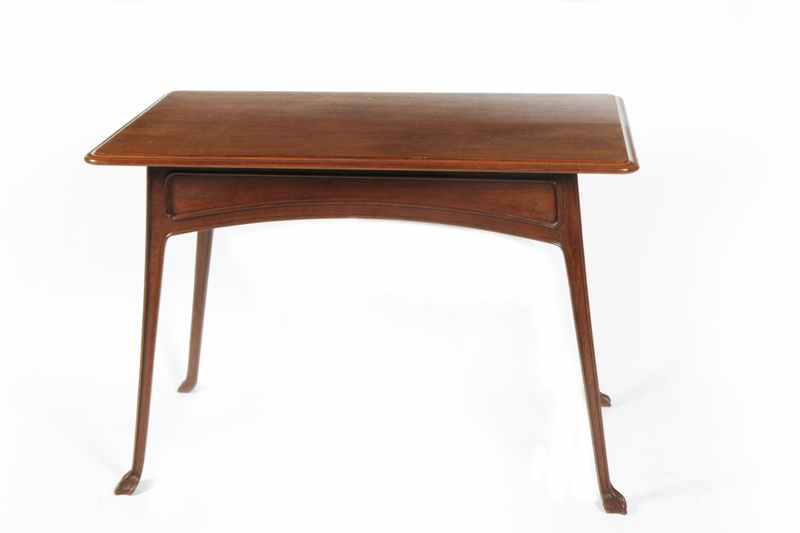 An Art Nouveau carved mahogany table designed by Edouard Colonna, rectangular top on slender