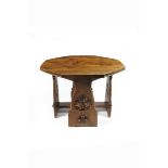 A Gothic Revival oak octagonal library table, with flaring pegged legs, carved with tracery