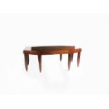 A large rosewood dining table, on eight swollen, reeded legs, with silvered bronze feet 199 x