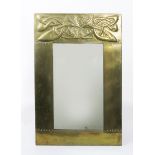 A large hammered brass wall mirror possibly designed by Harry Silver for Liberty & Co, rectangular,