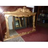 A gilt framed overmantle mirror of rectangular form with applied trailing floral and scrolling