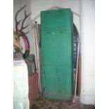 A substantial floorstanding green painted pine framed pantry cupboard enclosed by two rectangular