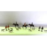 A vintage painted lead assembly of a hunting group comprising three riders on mounts, four