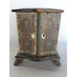 A miniature 19th century bank of three small drawers, in the form of an armoire, principally in