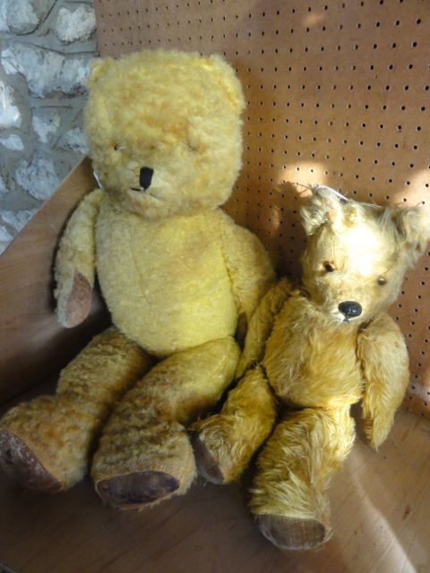 Two vintage teddy bears with inset glass eyes and padded paws