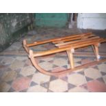 A vintage wooden toboggan with open slatted seat