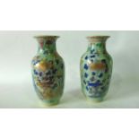 A pair of 19th century oriental vases of baluster form in the Cantonese manner with painted and