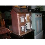 A vintage childs dolls house timber framed with hand painted simulated red brickwork façade
