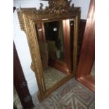 A 19th century gilt framed wall mirror of rectangular form, with stepped and moulded outline,