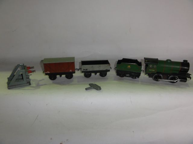 A quantity of 0 gauge model railway track together with a Hornby type 30 engine, rolling stock, etc