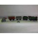 A quantity of 0 gauge model railway track together with a Hornby type 30 engine, rolling stock, etc