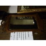 A 19th century fretted wall mirror with gilded bird surmount