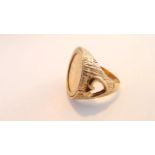 A 9ct gold half sovereign ring, 1982, the textured shoulders each with heart-shaped motif, size R,