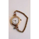 A lady's 9ct gold wristwatch, Rolex, the white enamelled dial with black and red Roman numerals, the