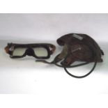 A 20th century leather aviation cap with audio fixture and associated goggles