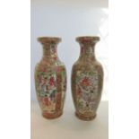 A pair of oriental vases of baluster shaped form with Cantonese style painted decoration of flowers,