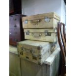 Three vintage vellum suitcases